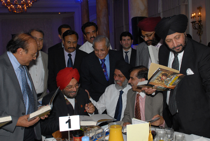 H. E. Gen JJ Singh signing copies